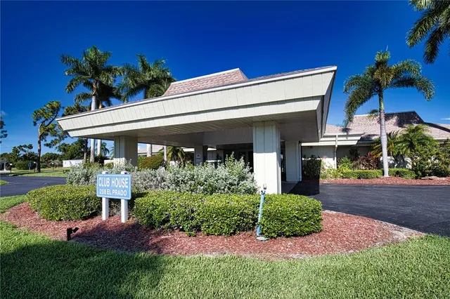 a view of a house with a yard and potted plants