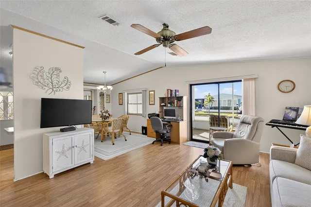 a view of a livingroom with furniture and a flat screen tv