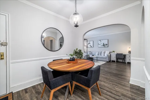 a dining room with furniture and a mirror