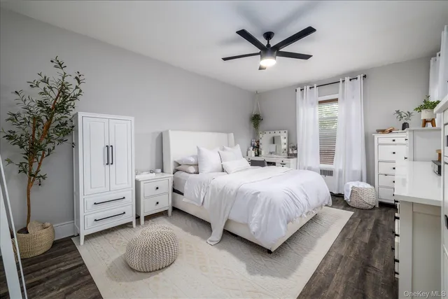a spacious bedroom with a bed and a chandelier
