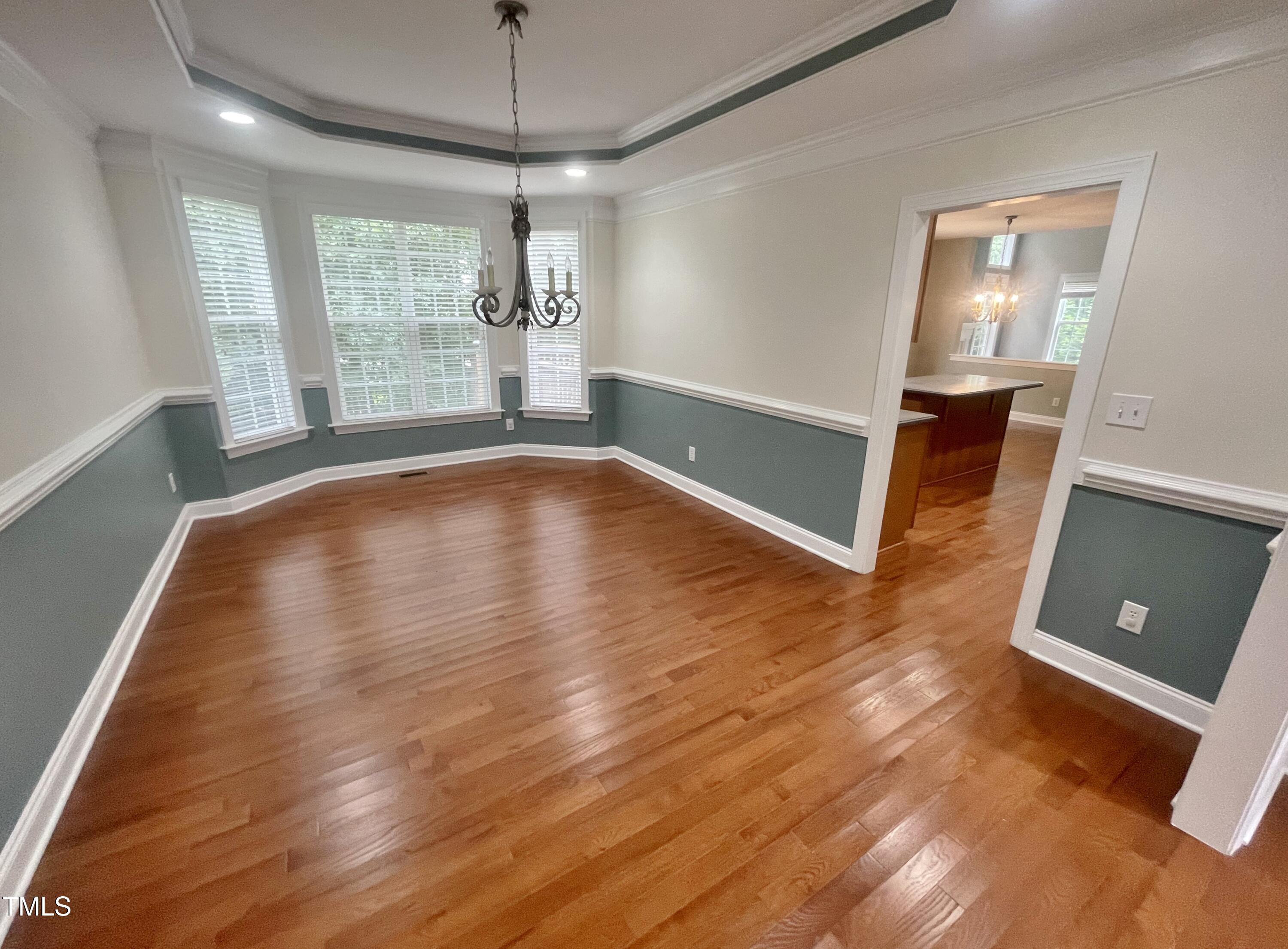 109 Bright Shade Court Holly Springs, NC 27540 - Photo 11 of 46 a view of empty room with wooden floor and fan