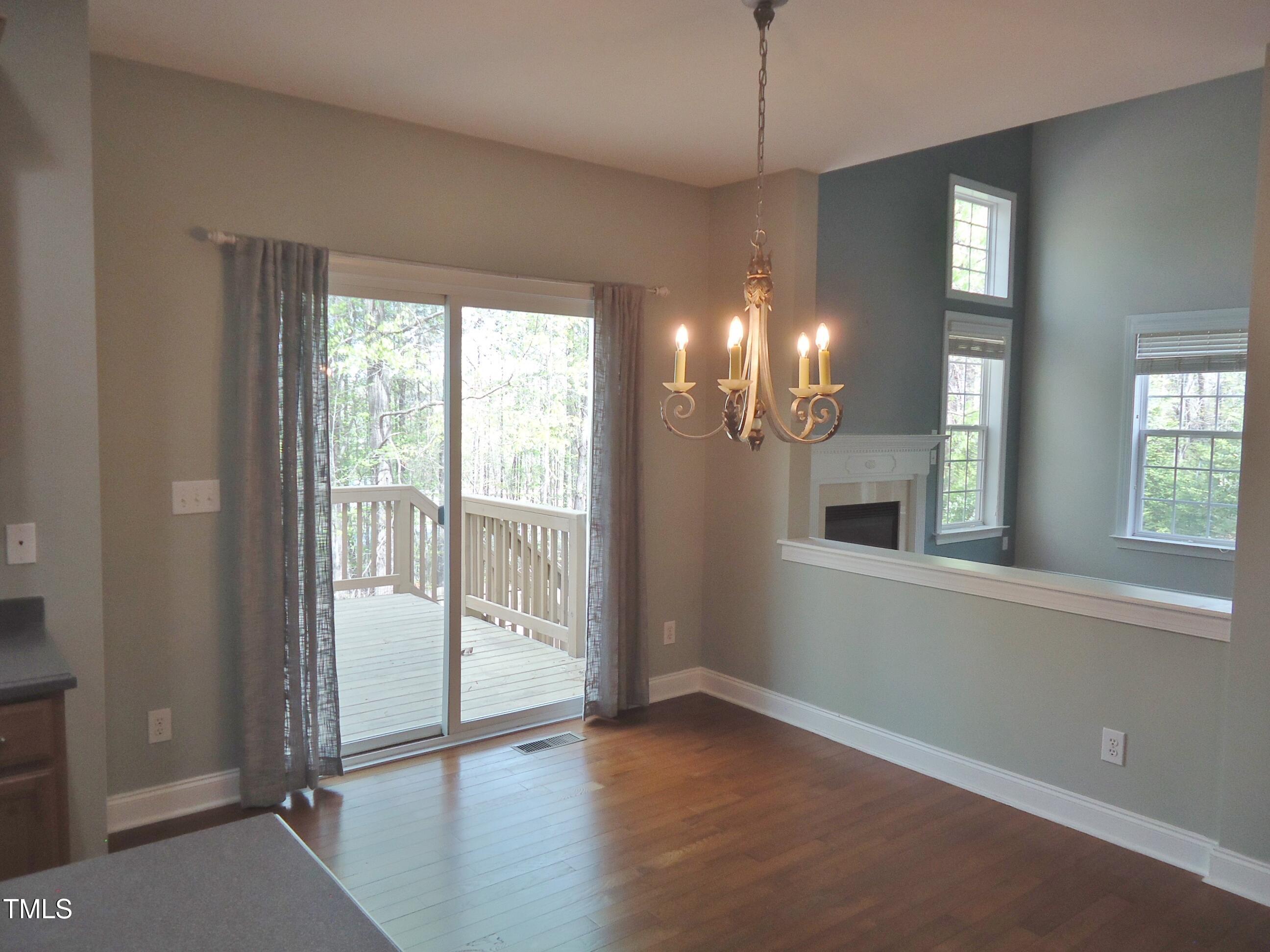 109 Bright Shade Court Holly Springs, NC 27540 - Photo 18 of 46 a view of an empty room with wooden floor and a window