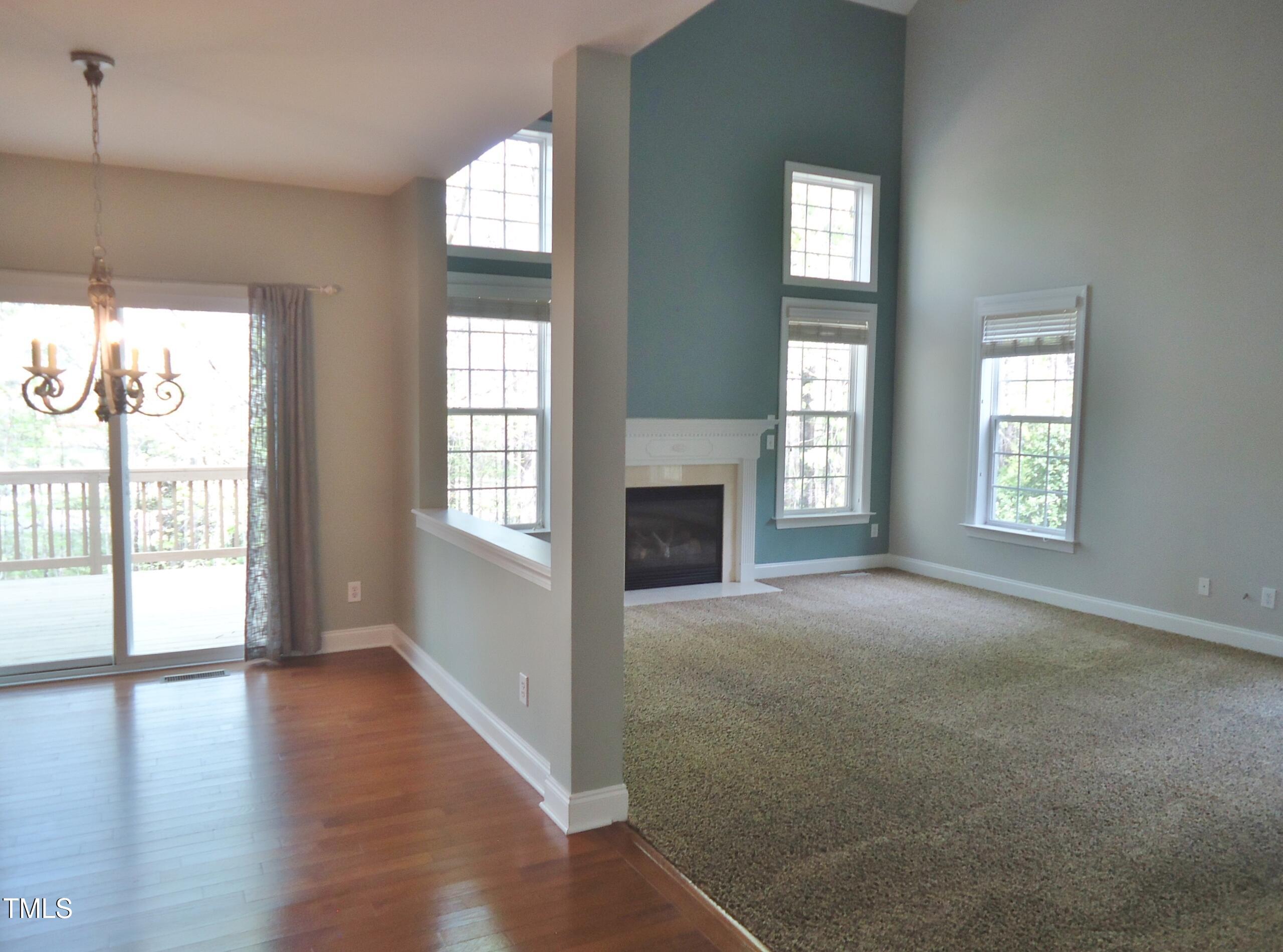 109 Bright Shade Court Holly Springs, NC 27540 - Photo 21 of 46 an empty room with wooden floor and windows