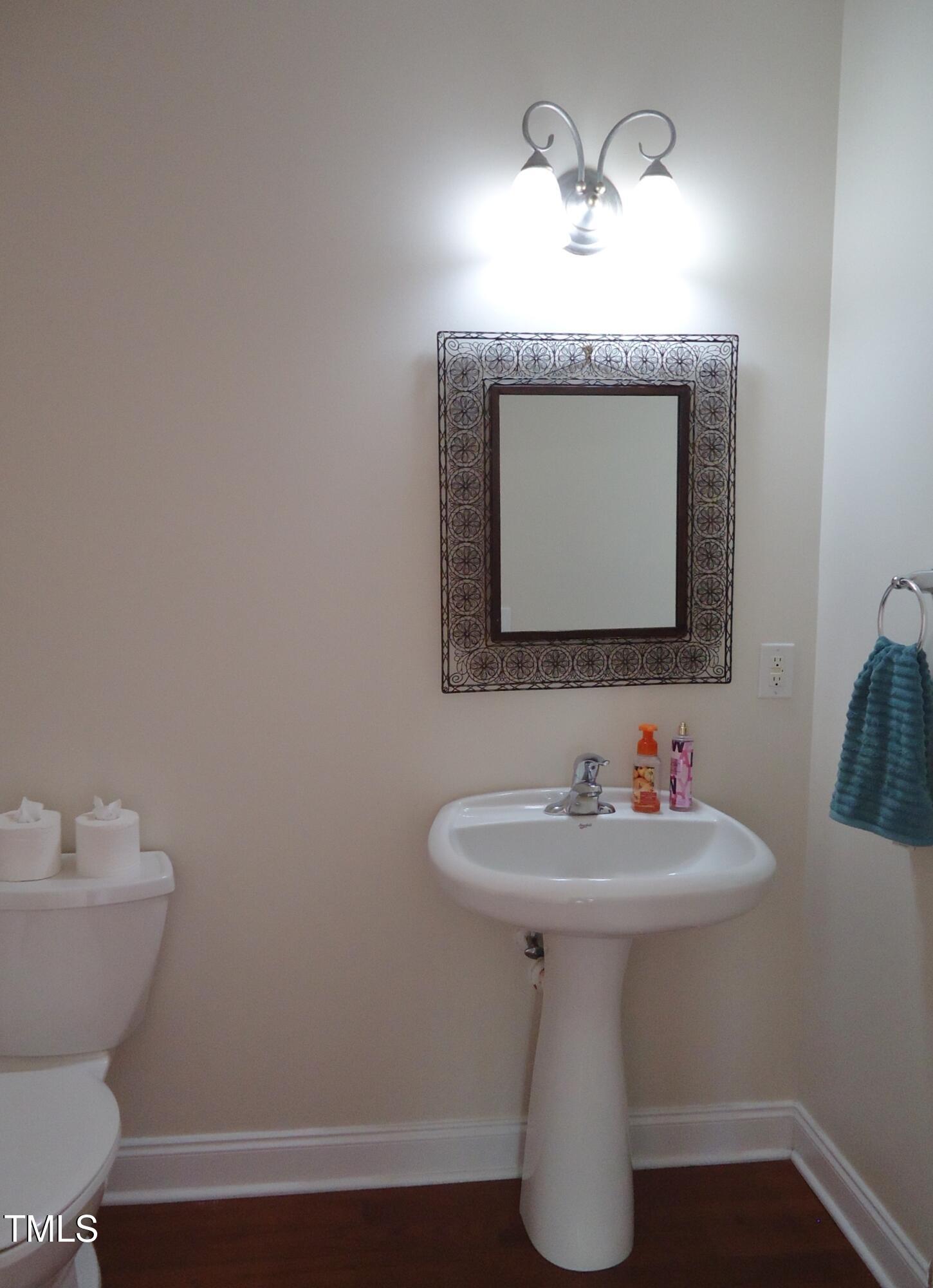 109 Bright Shade Court Holly Springs, NC 27540 - Photo 25 of 46 a bathroom with a sink and a mirror