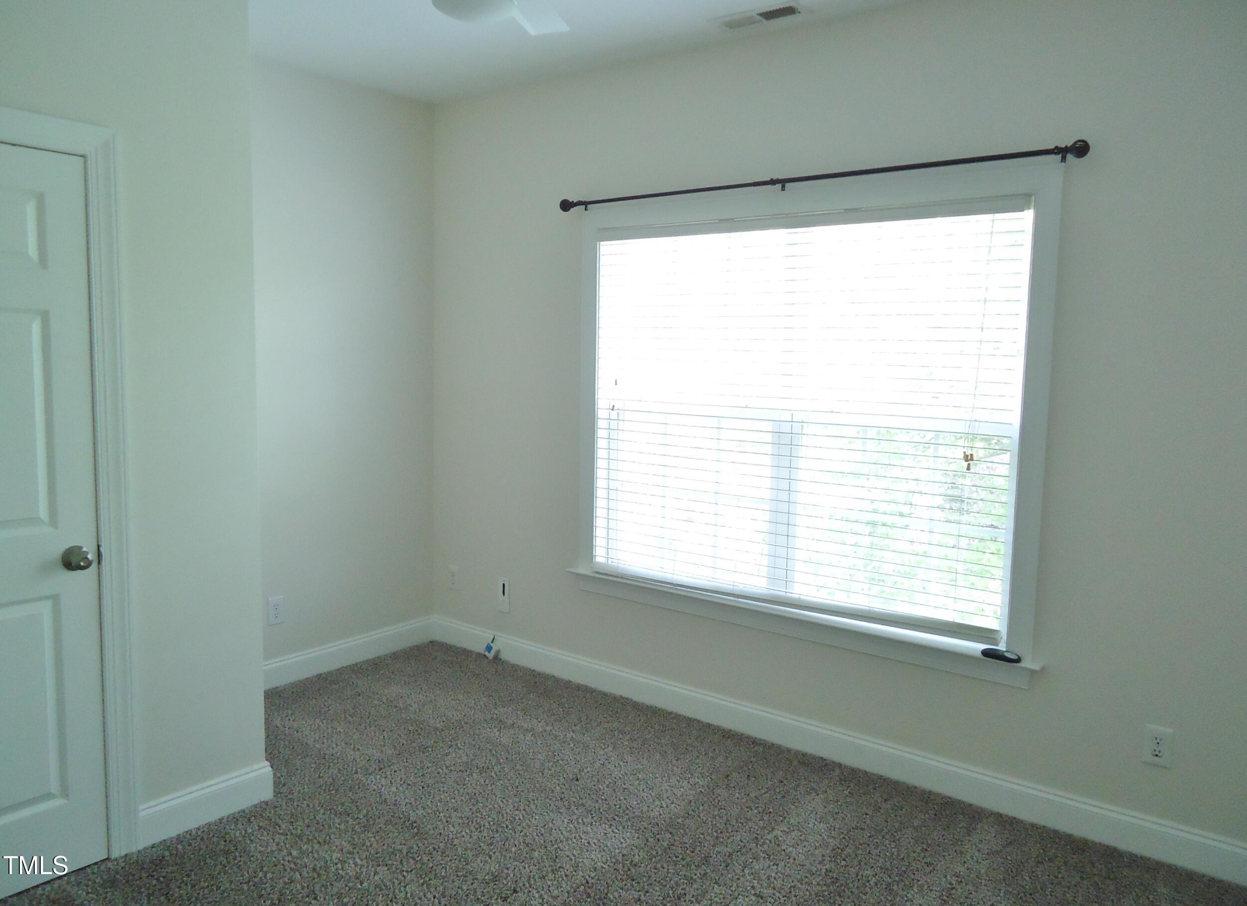 109 Bright Shade Court Holly Springs, NC 27540 - Photo 37 of 46 a room with a window and a chair
