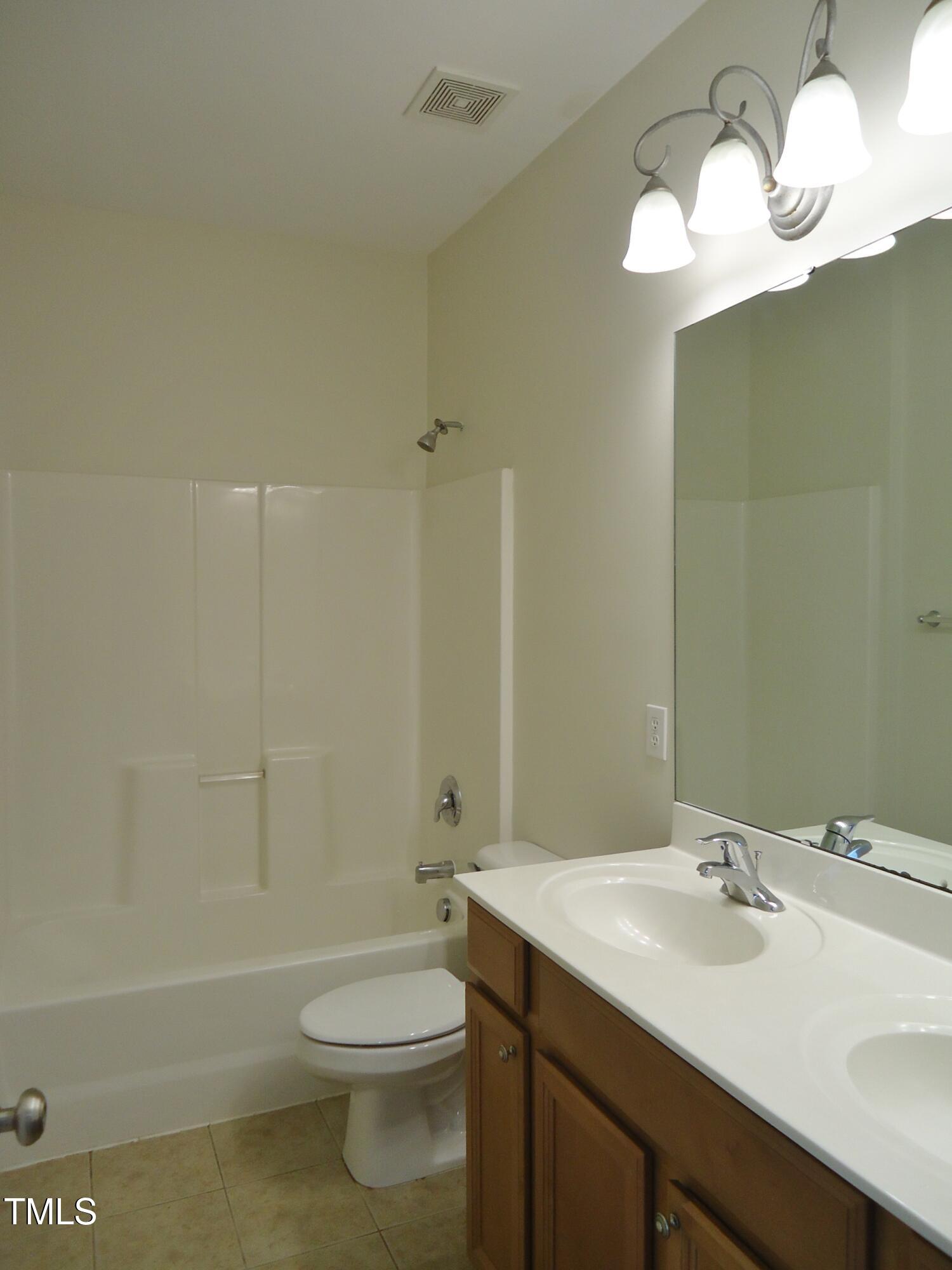 109 Bright Shade Court Holly Springs, NC 27540 - Photo 40 of 46 a bathroom with a sink a toilet and shower