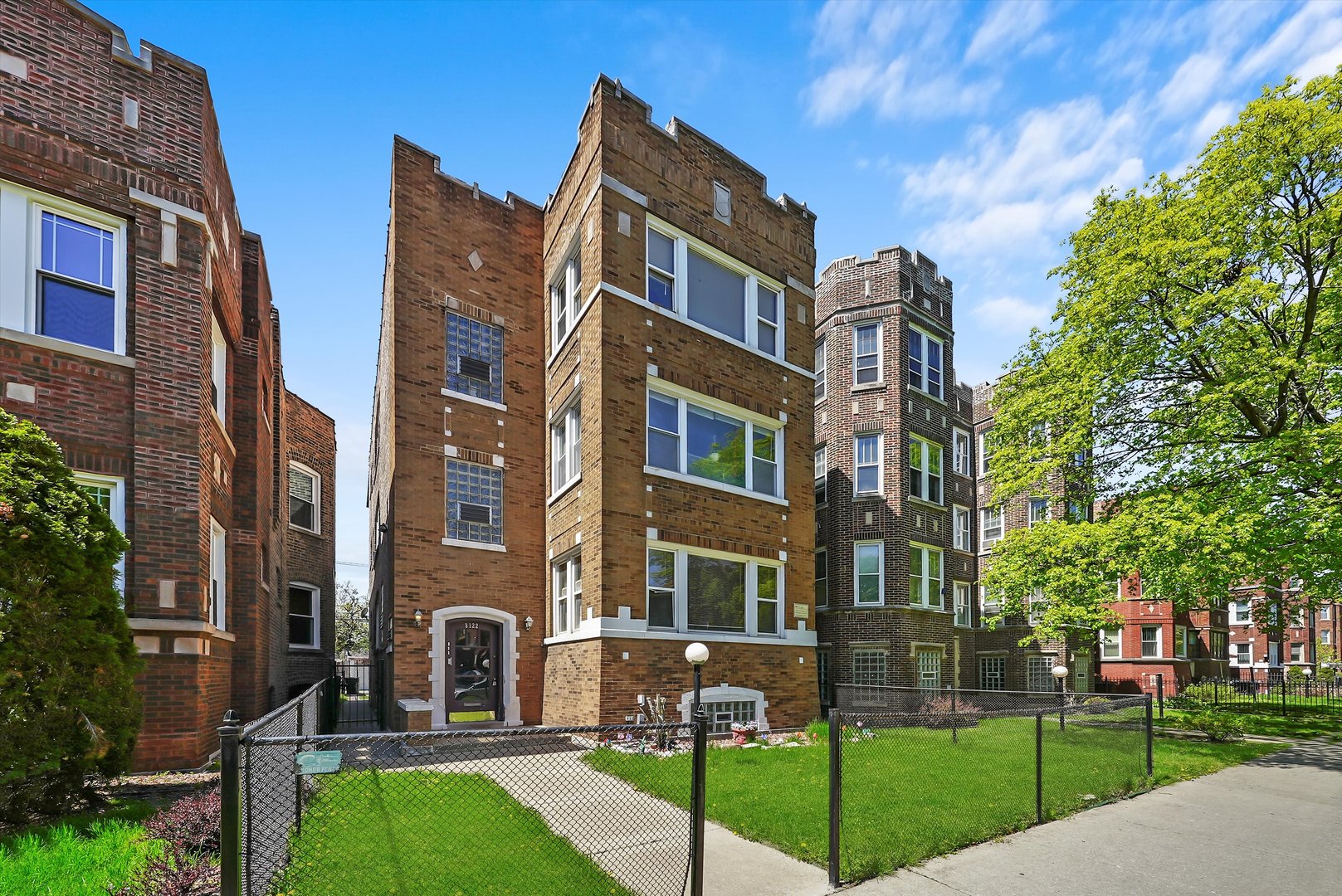8122 South Evans Avenue Chicago, IL 60619 - Photo 1 of 10 a view of a brick building next to a yard