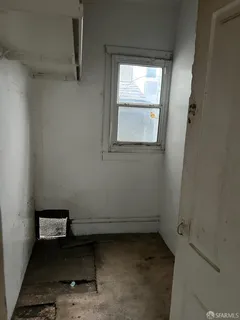 a view of a room with rack on the wall and a window