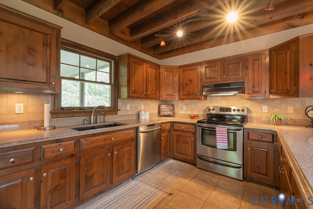 5146 Studley Road Mechanicsville, VA 23116 - Photo 15 of 50 a kitchen with stainless steel appliances granite countertop wooden cabinets sink stove and microwave