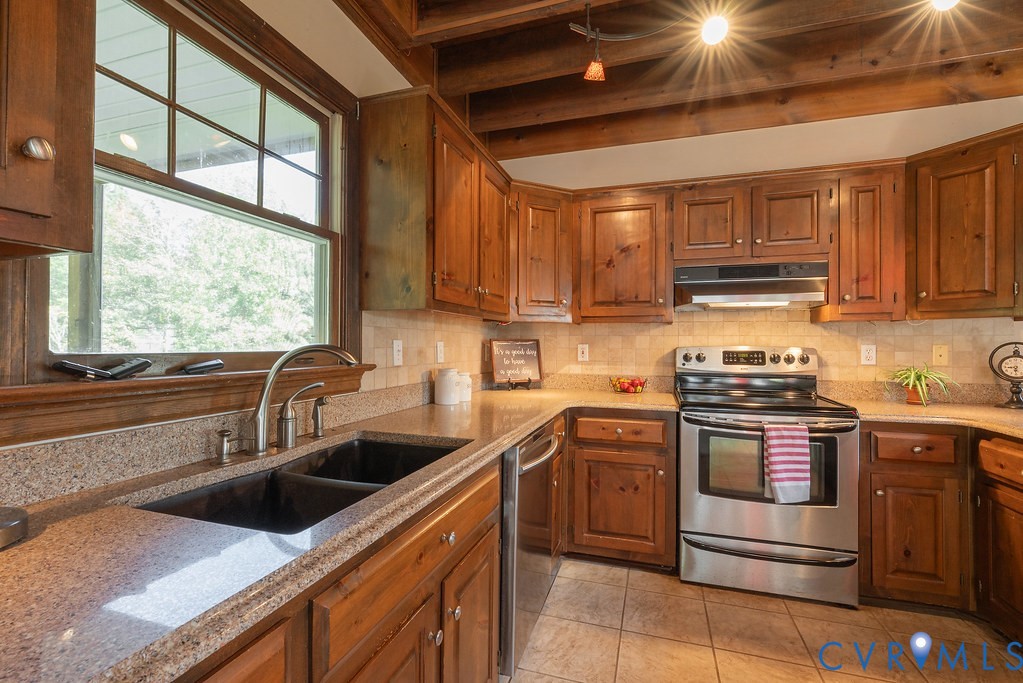 5146 Studley Road Mechanicsville, VA 23116 - Photo 16 of 50 a kitchen with stainless steel appliances granite countertop a sink a stove and a microwave
