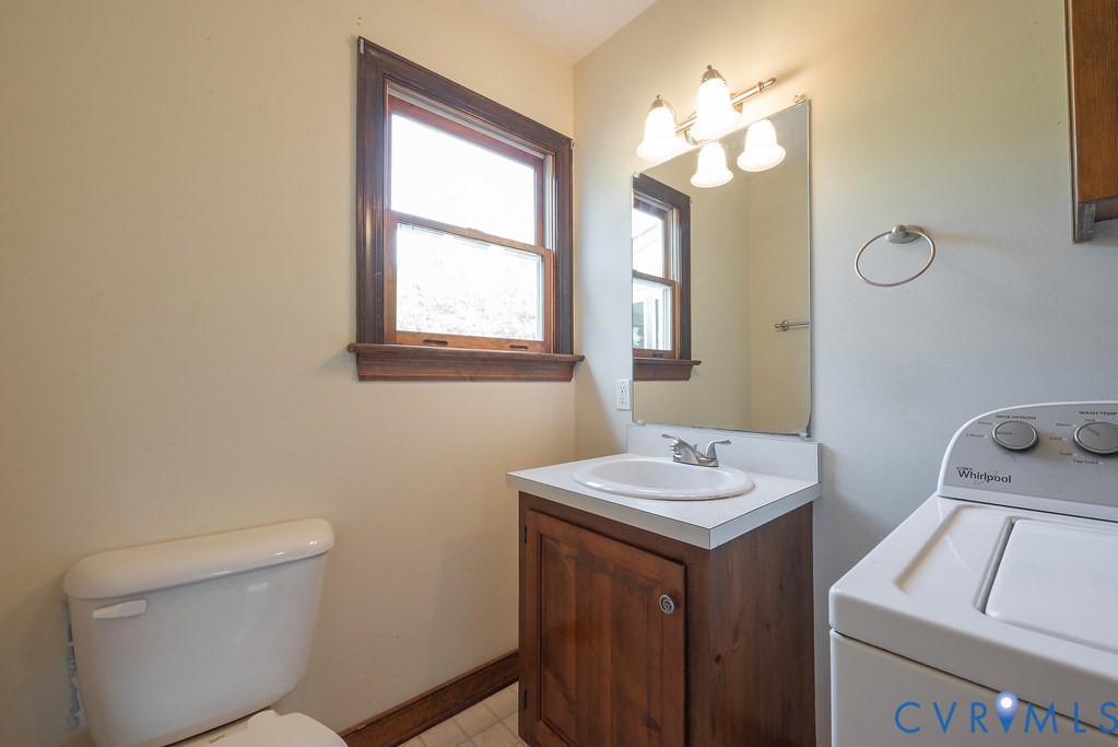 5146 Studley Road Mechanicsville, VA 23116 - Photo 25 of 50 a bathroom with a toilet sink and mirror