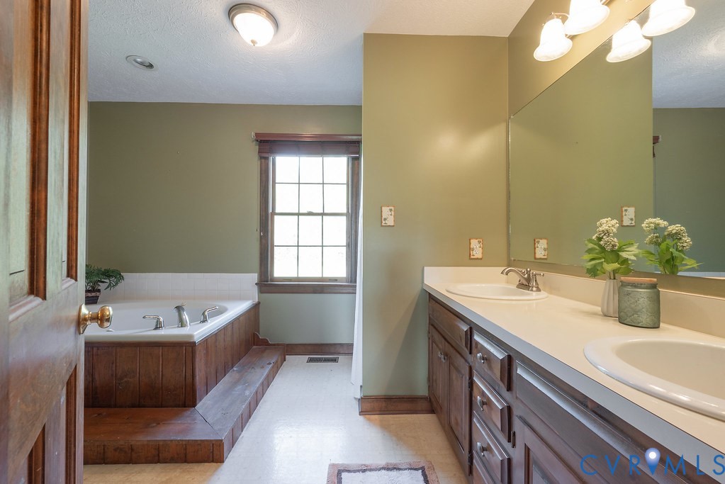 5146 Studley Road Mechanicsville, VA 23116 - Photo 27 of 50 a bathroom with a tub sink and mirror