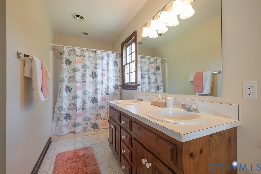 5146 Studley Road Mechanicsville, VA 23116 - Photo 34 of 50 a bathroom with a sink a double vanity and a mirror