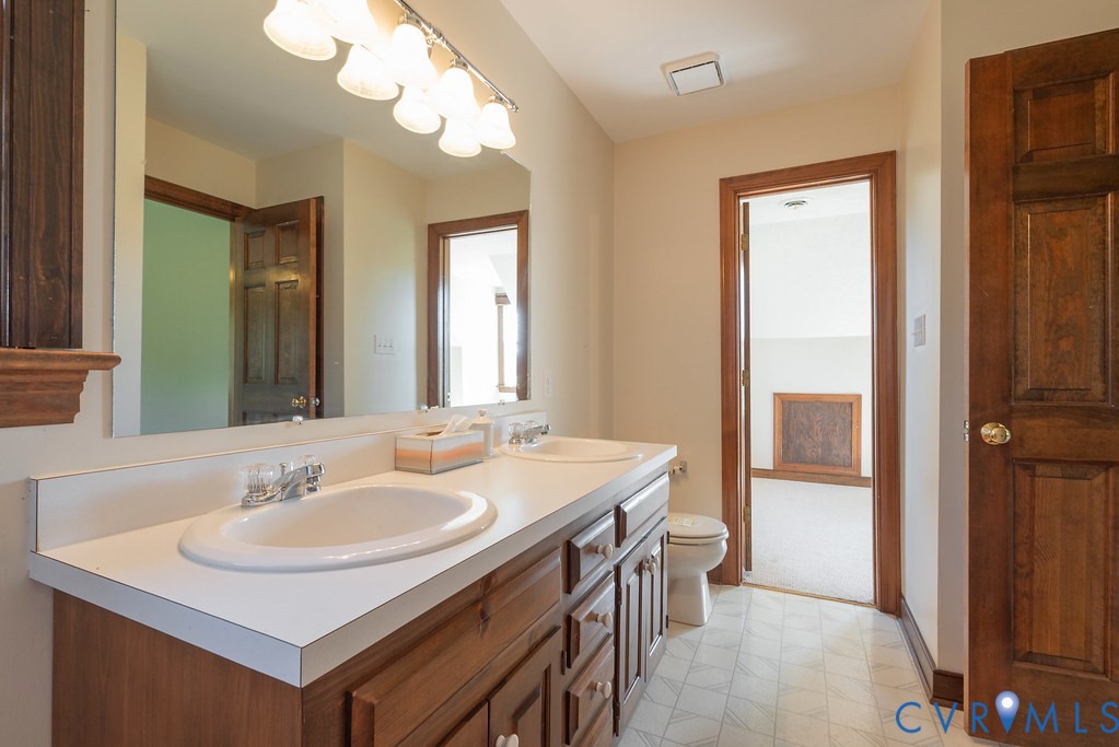 5146 Studley Road Mechanicsville, VA 23116 - Photo 35 of 50 a bathroom with a sink a vanity and a mirror