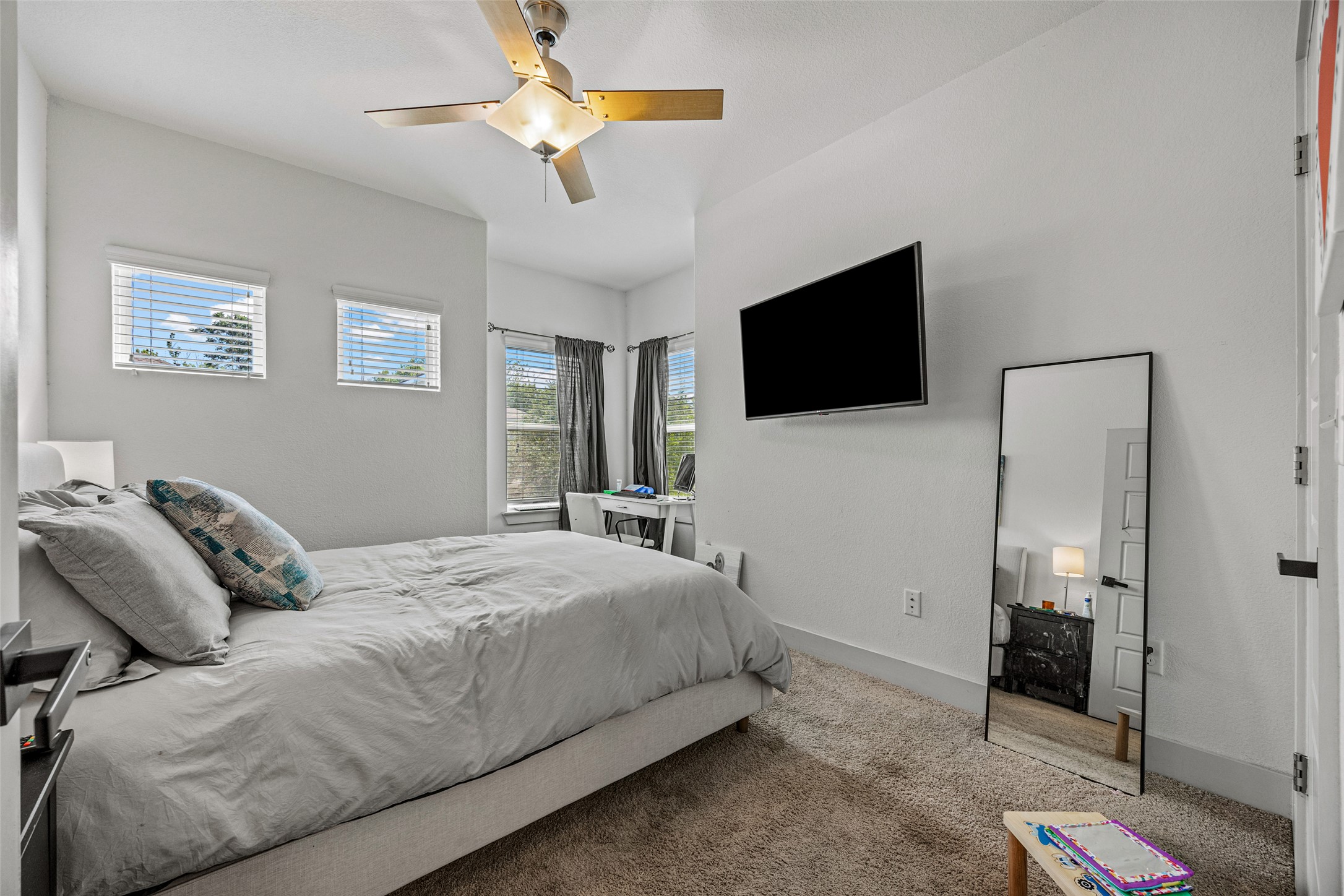 1408 Homespun Road Austin, TX 78745 - Photo 18 of 20 A comfortable bedroom features high ceilings and ample natural light, ideal for relaxation or productivity.