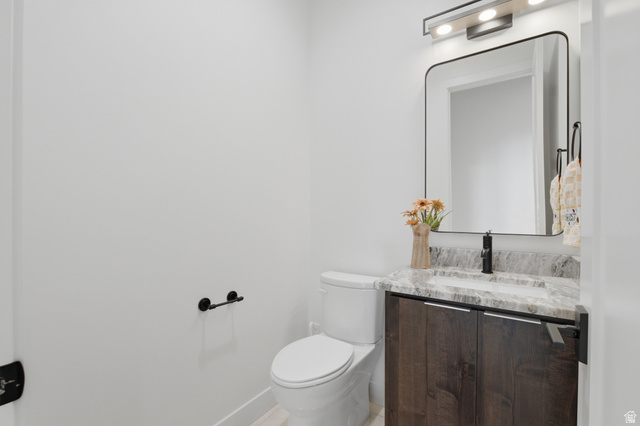 1445 Jacob Road Sandy, UT 84092 - Photo 35 of 52 Modern vanity with dark wood-finish cabinetry, light-toned countertop, rectangular sink, and matte black faucet