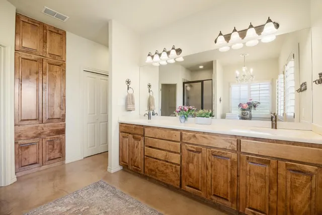 a spacious bathroom with a double vanity sink and a mirror