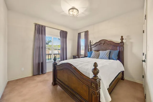 a bed sitting in a bedroom next to a window