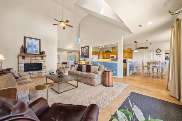 a living room with fireplace furniture and a table