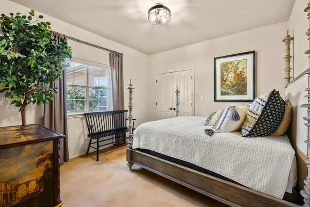 a bedroom with a bed and a window