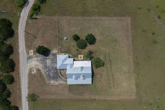 an aerial view of a house with a yard