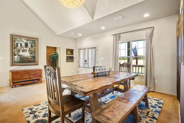 a dining room with furniture and a window