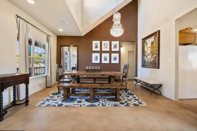 a living room with furniture a wooden floor and a large window