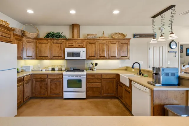 a kitchen with stainless steel appliances granite countertop a stove sink and cabinets