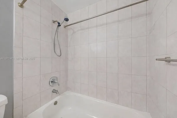 a bathroom with a shower and a bath tub