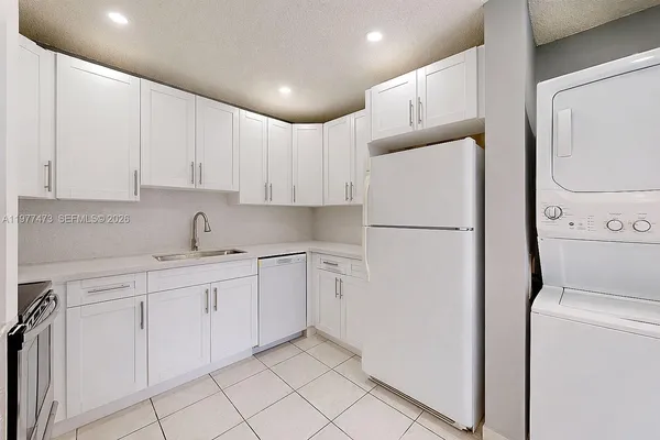 a white refrigerator freezer sitting inside of a kitchen