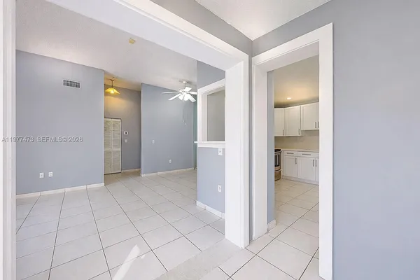 a view of an empty room and a bathroom