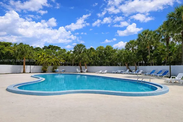 a view of a swimming pool with a yard