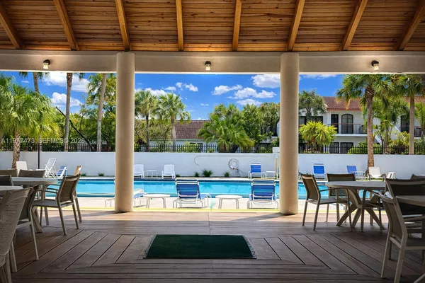 a view of a patio with a table and chairs
