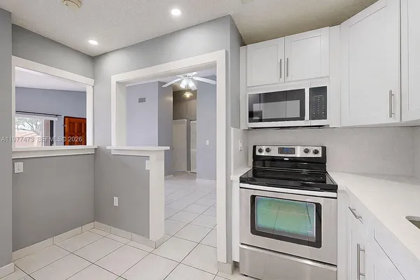 a kitchen with cabinets and steel appliances
