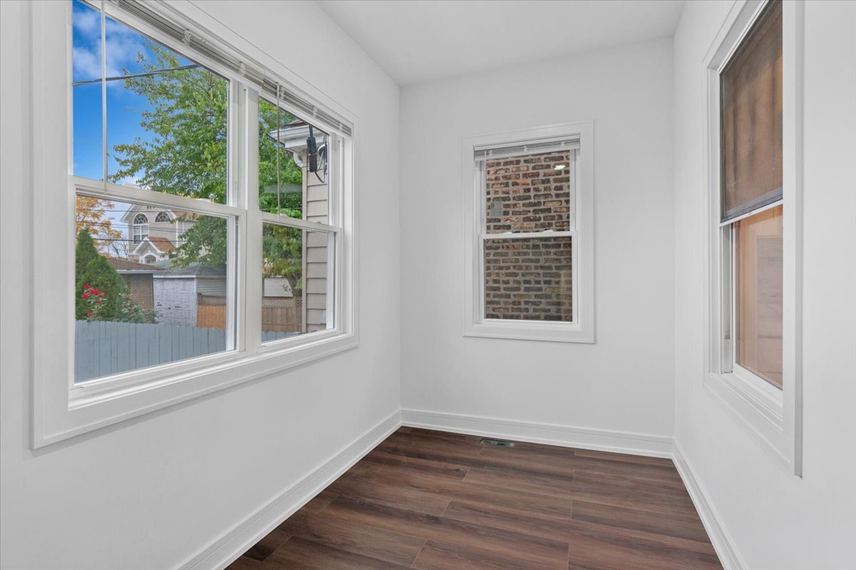 2159 North Parkside Avenue Chicago, IL 60639 - Photo 11 of 23 a view of an empty room with wooden floor and a window