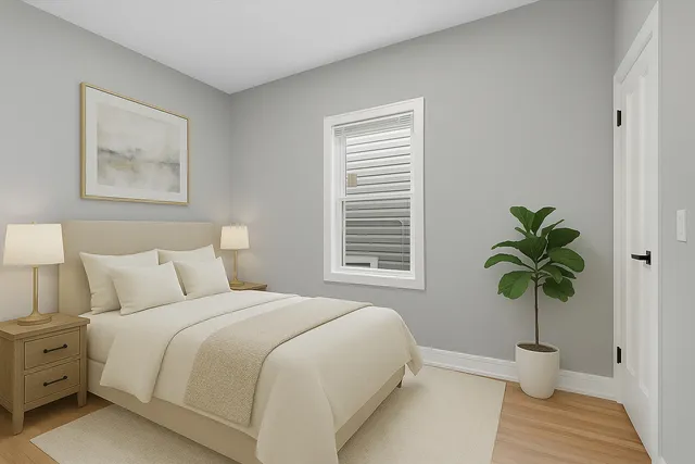 a bedroom with a bed potted plant and a window