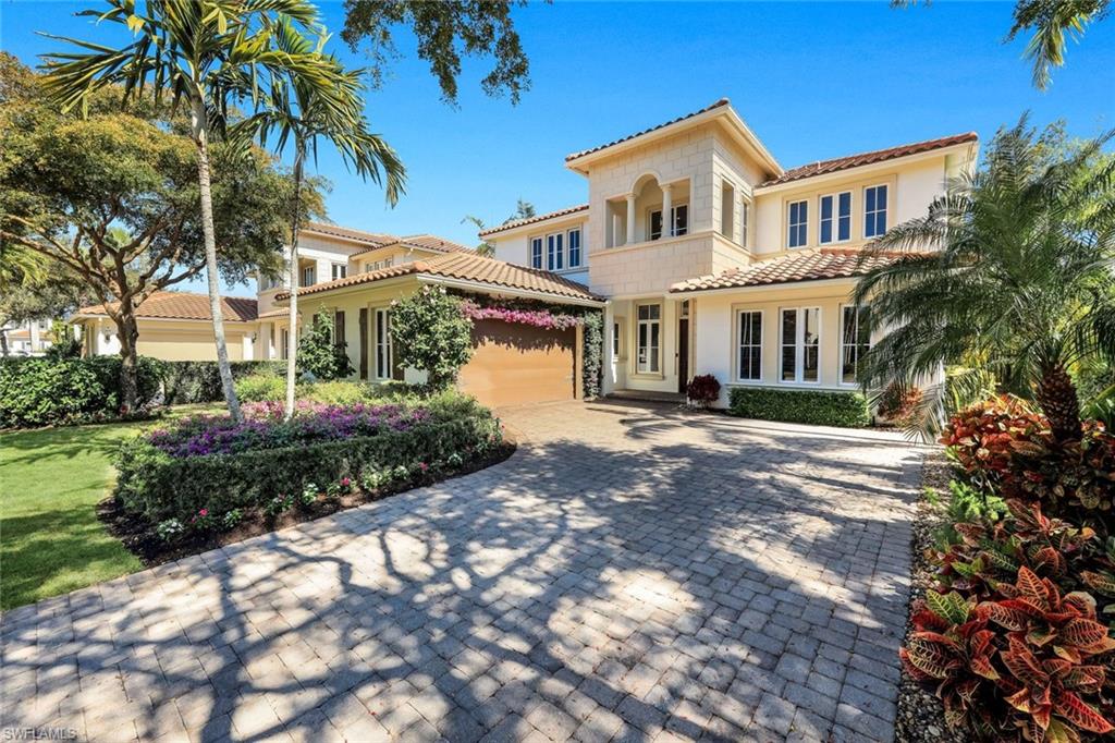 2106 Modena Court Naples, FL 34105 - Photo 3 of 42 a front view of a house with a garden