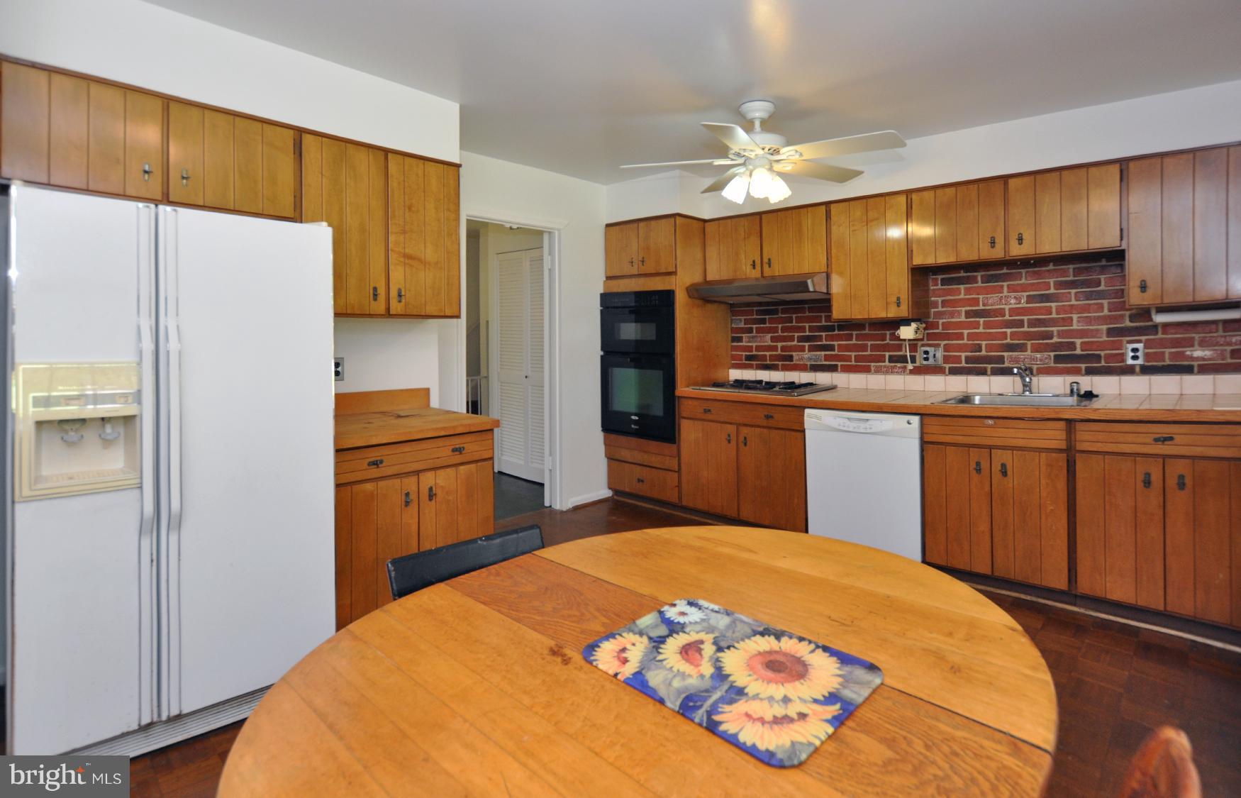 12906 Stonecrest Drive Silver Spring, MD 20904 - Photo 8 of 17 a kitchen with stainless steel appliances a sink cabinets and wooden floor