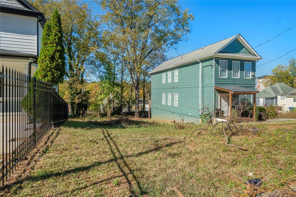 148 Maple Street Northwest Atlanta, GA 30314 - Photo 8 of 16 a front view of a house with a yard