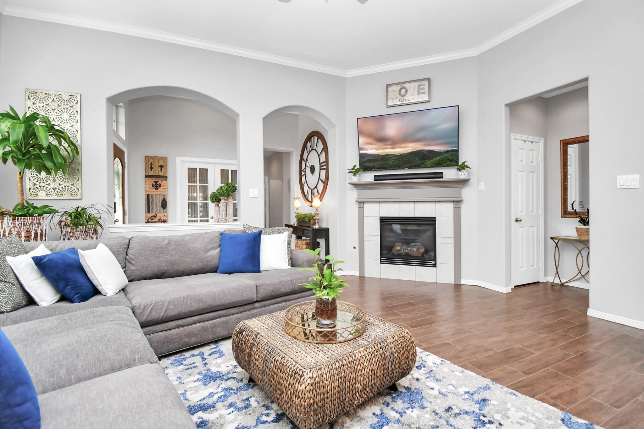 8624 Sunset Loch Drive Spring, TX 77379 - Photo 6 of 44 a living room with furniture a flat screen tv and a fireplace