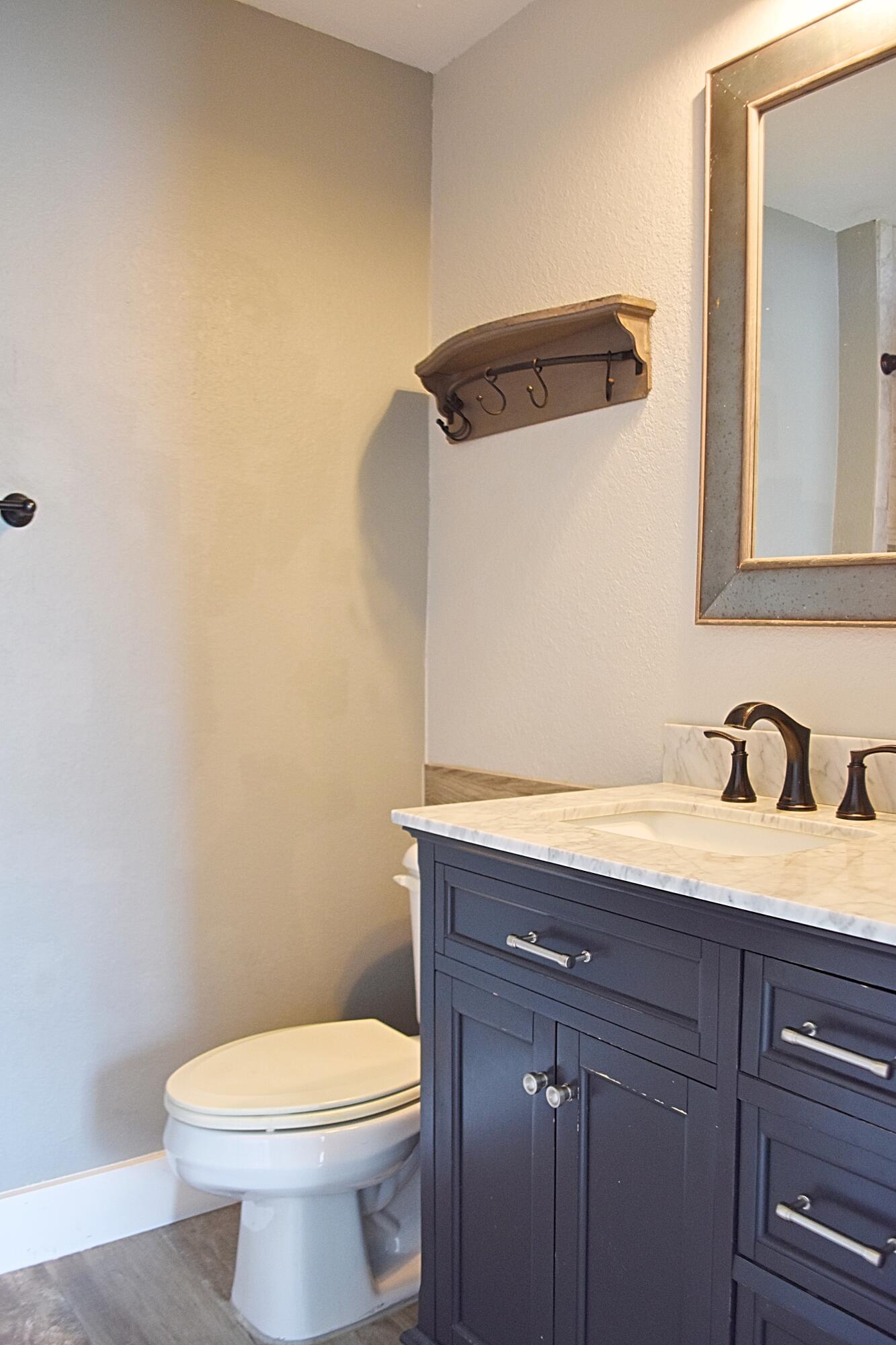 18 South Sand Palm Road, Unit 51 Freeport, FL 32439 - Photo 16 of 16 a bathroom with a granite countertop toilet and a sink