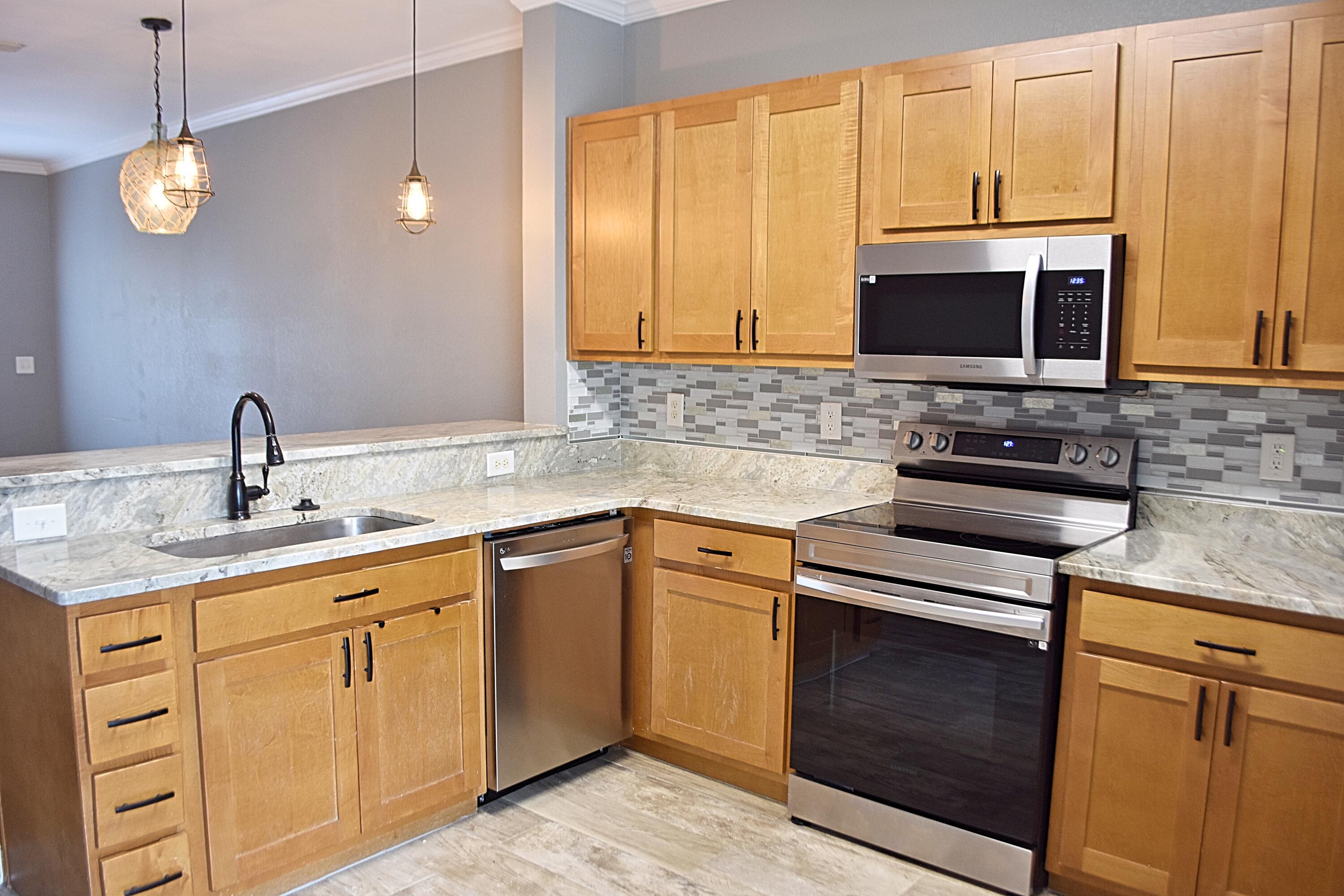 18 South Sand Palm Road, Unit 51 Freeport, FL 32439 - Photo 5 of 16 a kitchen with cabinets appliances and a sink