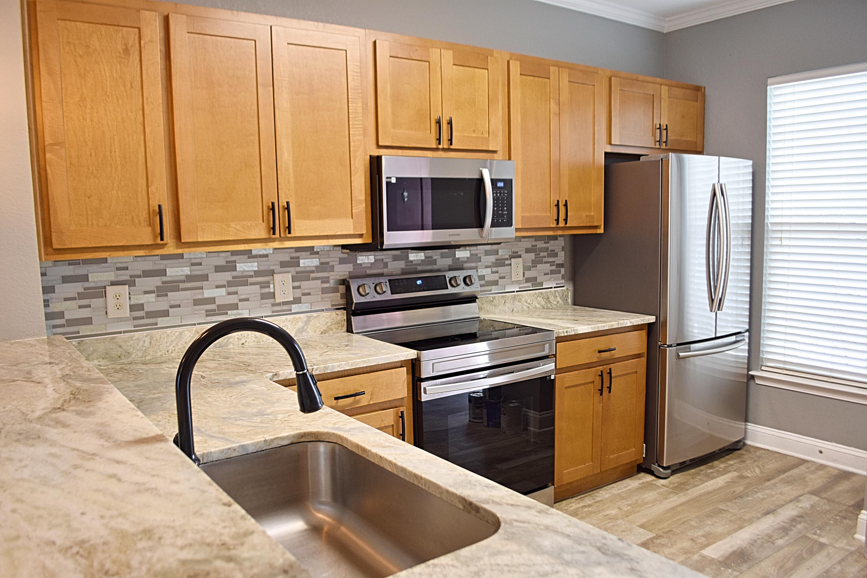 18 South Sand Palm Road, Unit 51 Freeport, FL 32439 - Photo 6 of 16 a kitchen with stainless steel appliances granite countertop a refrigerator a stove a sink and a counter space