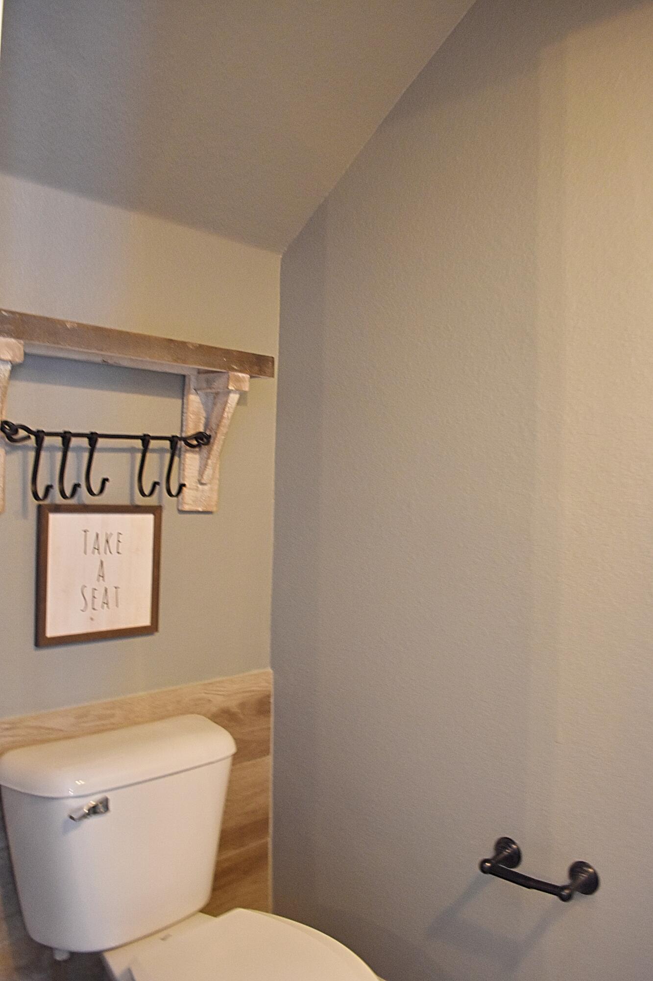18 South Sand Palm Road, Unit 51 Freeport, FL 32439 - Photo 8 of 16 a white toilet sitting next to a bathroom sink