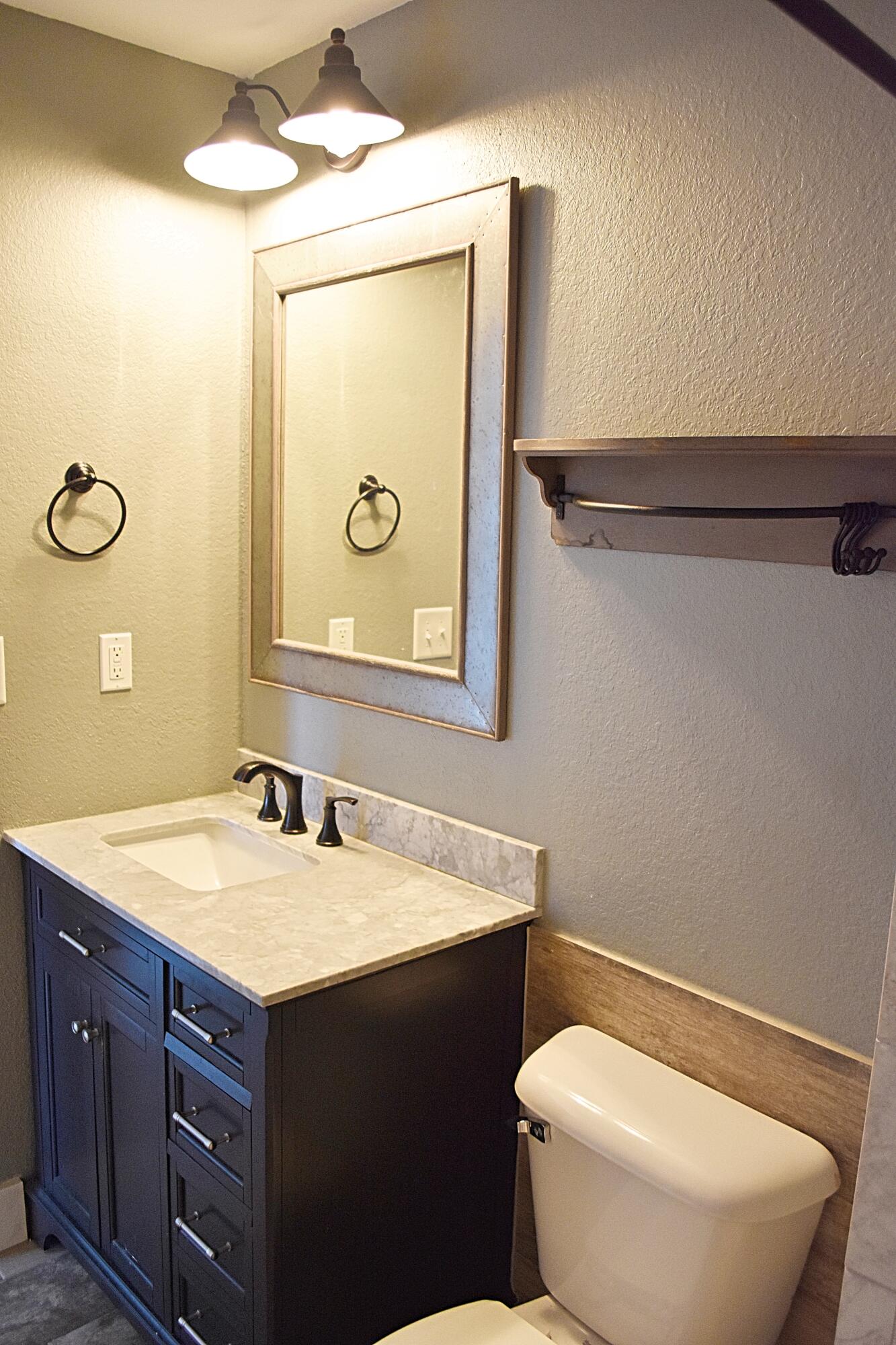 18 South Sand Palm Road, Unit 51 Freeport, FL 32439 - Photo 10 of 16 a bathroom with a toilet sink vanity and mirror