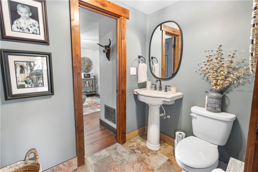 308 Hugh Stowers Road Dawsonville, GA 30534 - Photo 12 of 81 a bathroom with a toilet a sink and a mirror