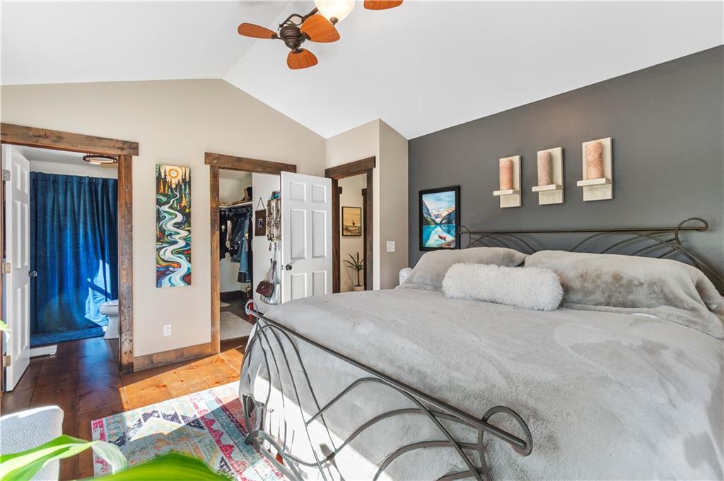 308 Hugh Stowers Road Dawsonville, GA 30534 - Photo 35 of 81 a bedroom with a bed and a chandelier