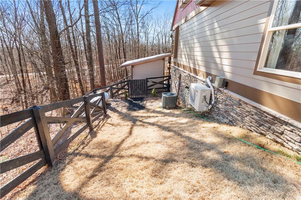 308 Hugh Stowers Road Dawsonville, GA 30534 - Photo 66 of 81 a view of a back yard of the house with a bench