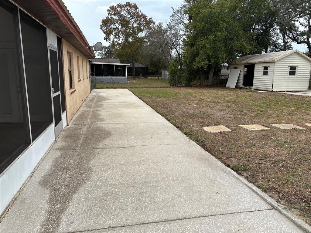 10305 Bannister Street Spring Hill, FL 34608 - Photo 6 of 24 a view of house with backyard and tree