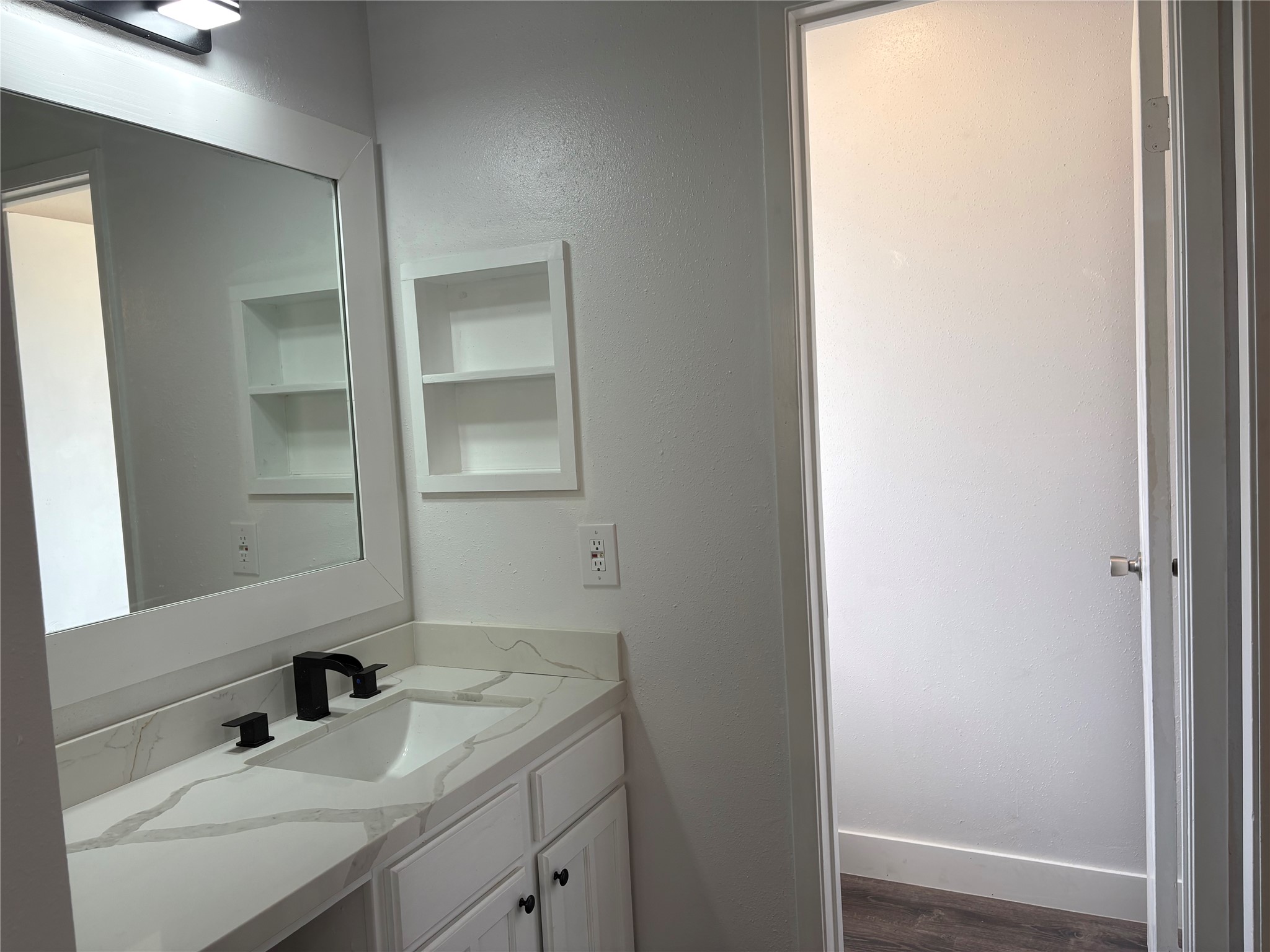 4631 Enchanted Rock Lane Spring, TX 77388 - Photo 4 of 10 Bathroom with vanity and dark wood-style flooring